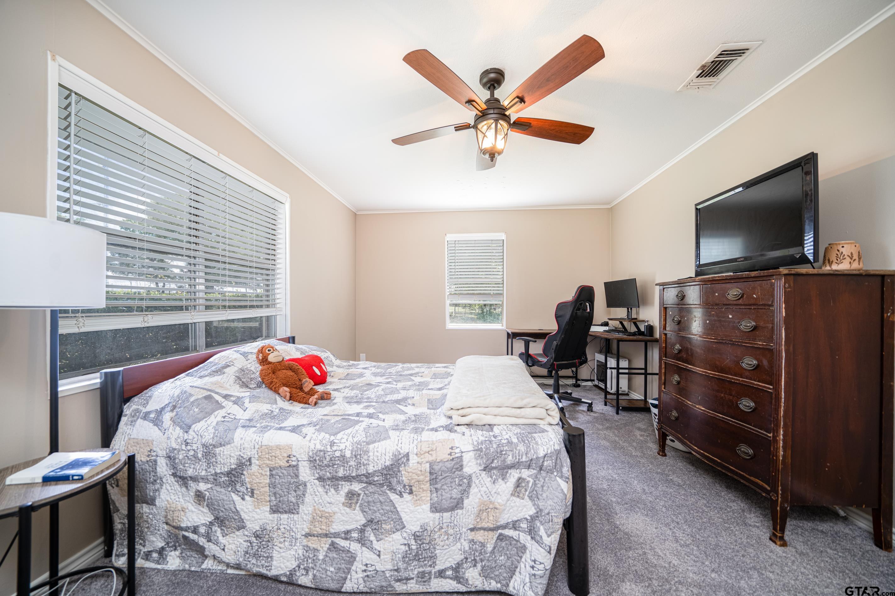 2536 Elk Road Gilmer, TX 75644 - Photo 20 of 32 a bedroom with a bed and a flat screen tv