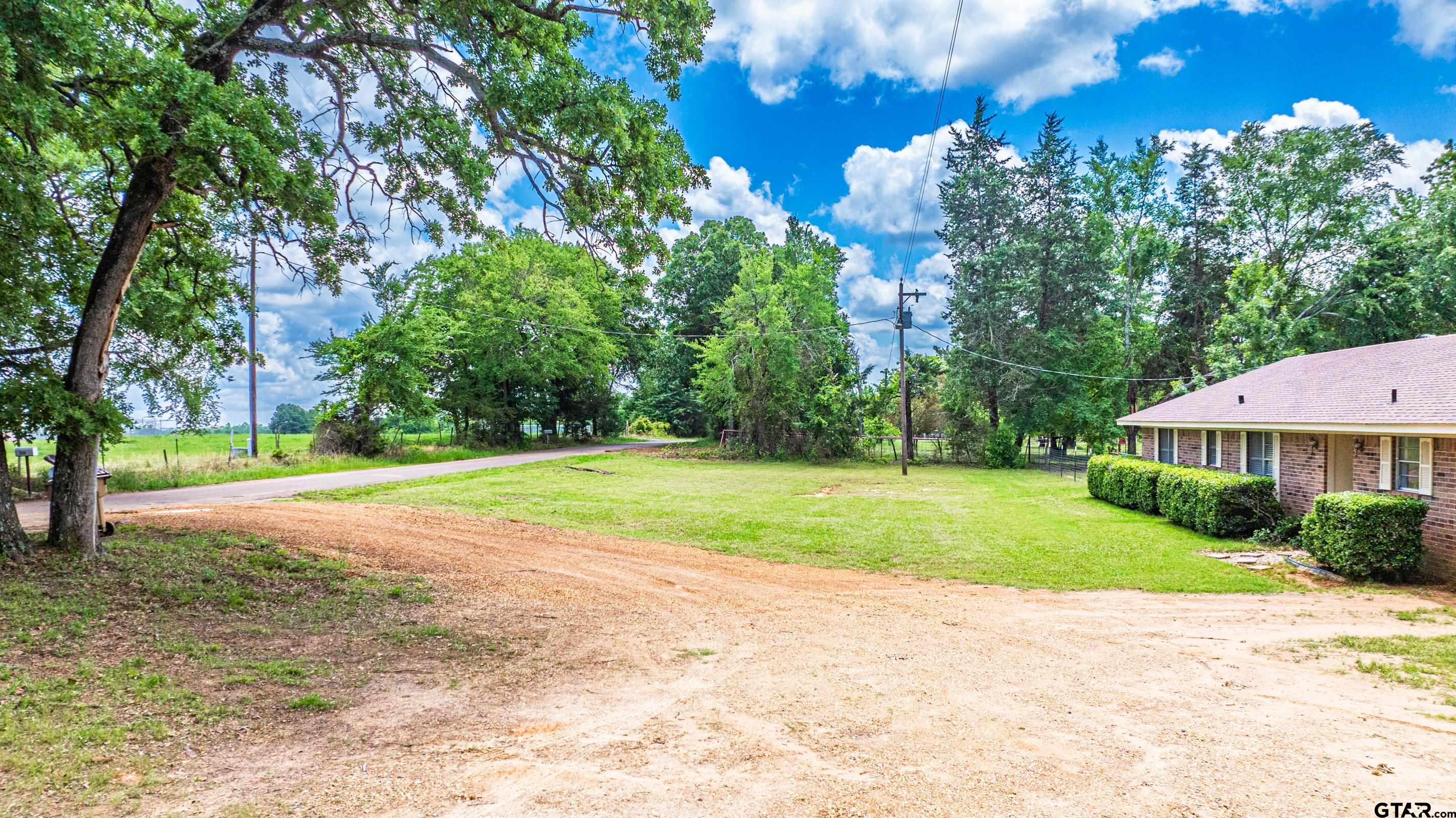 2536 Elk Road Gilmer, TX 75644 - Photo 2 of 32 a view of a house with a yard and basketball court