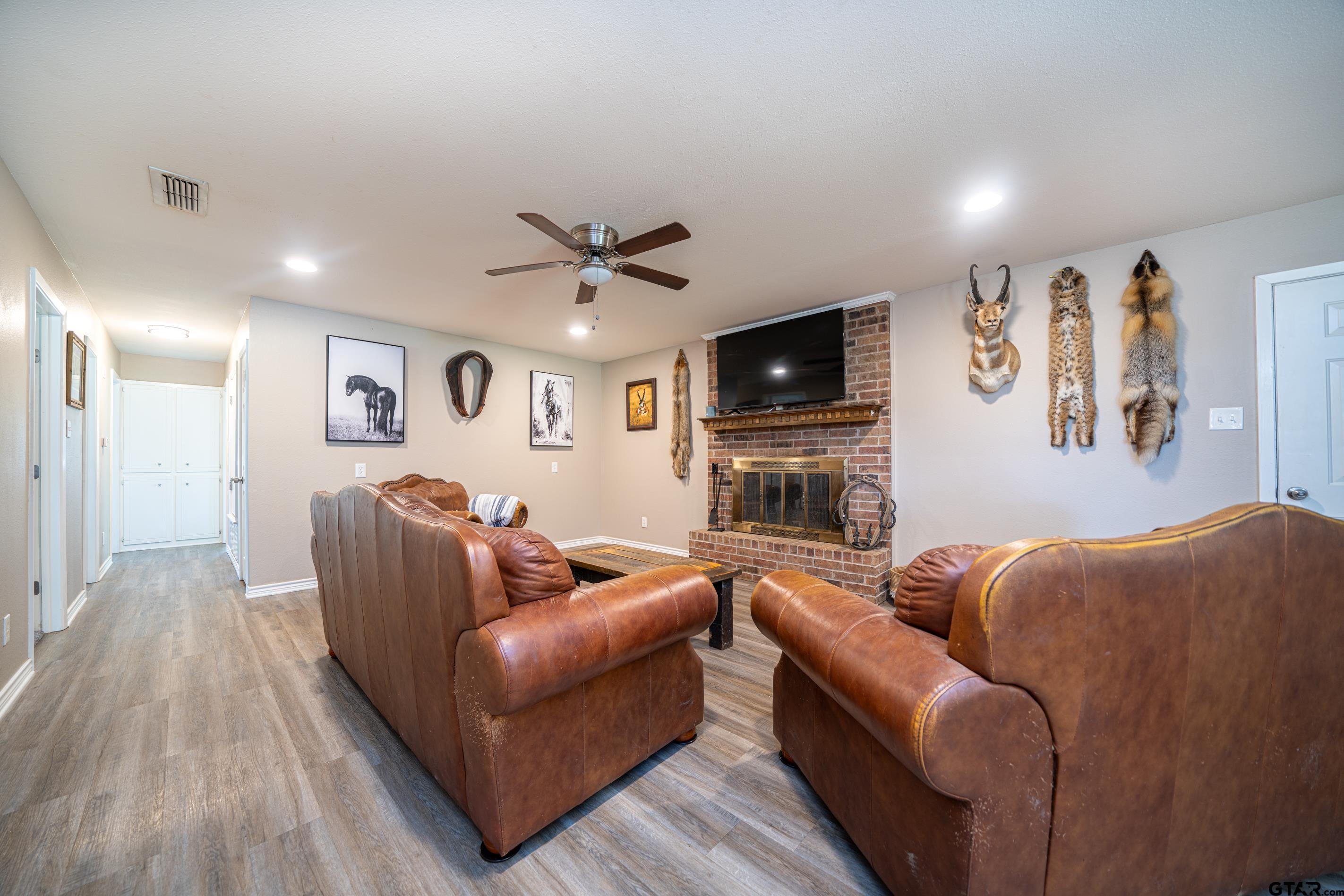 2536 Elk Road Gilmer, TX 75644 - Photo 4 of 32 a living room with furniture a flat screen tv and a fireplace