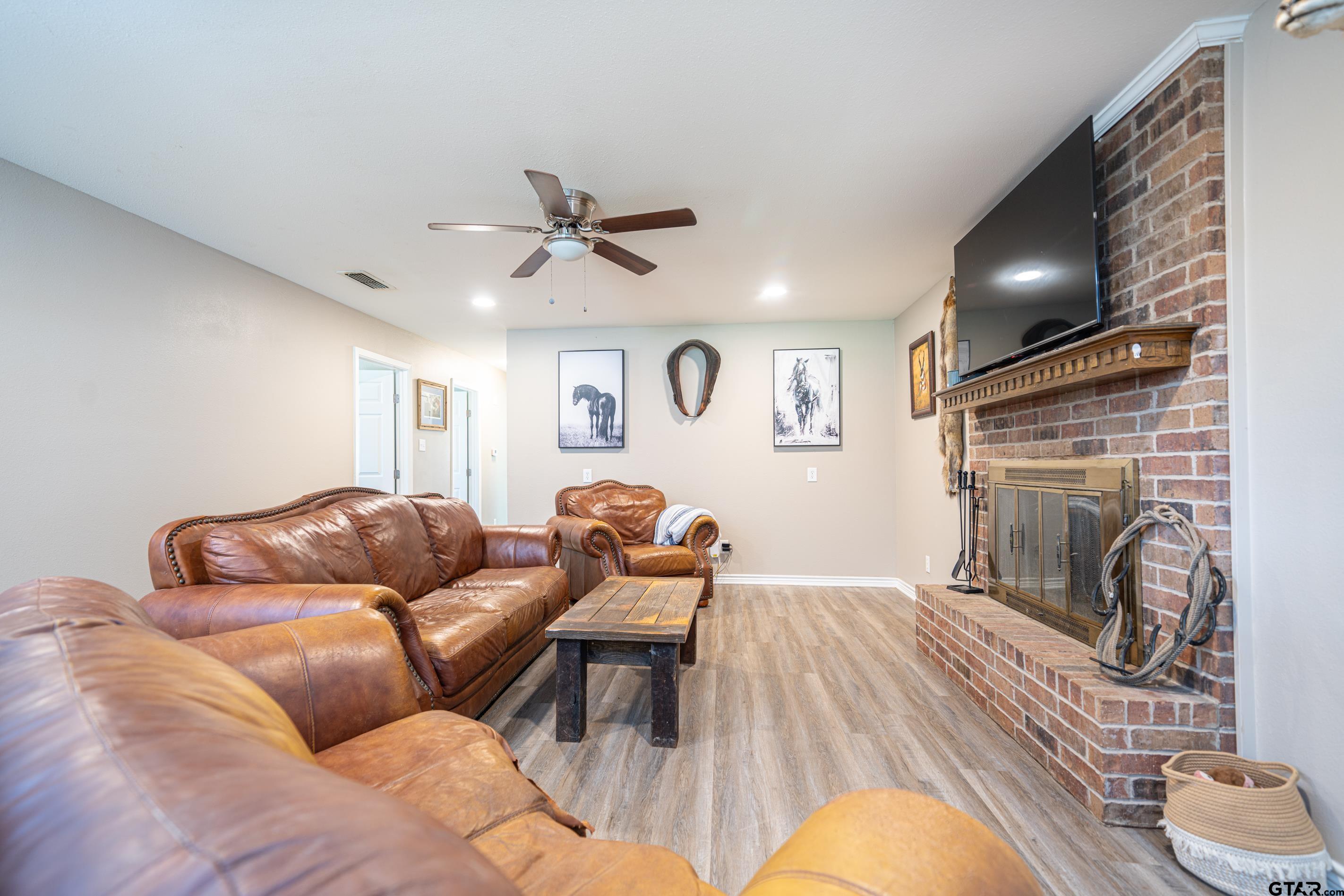 2536 Elk Road Gilmer, TX 75644 - Photo 5 of 32 a living room with furniture and a fireplace