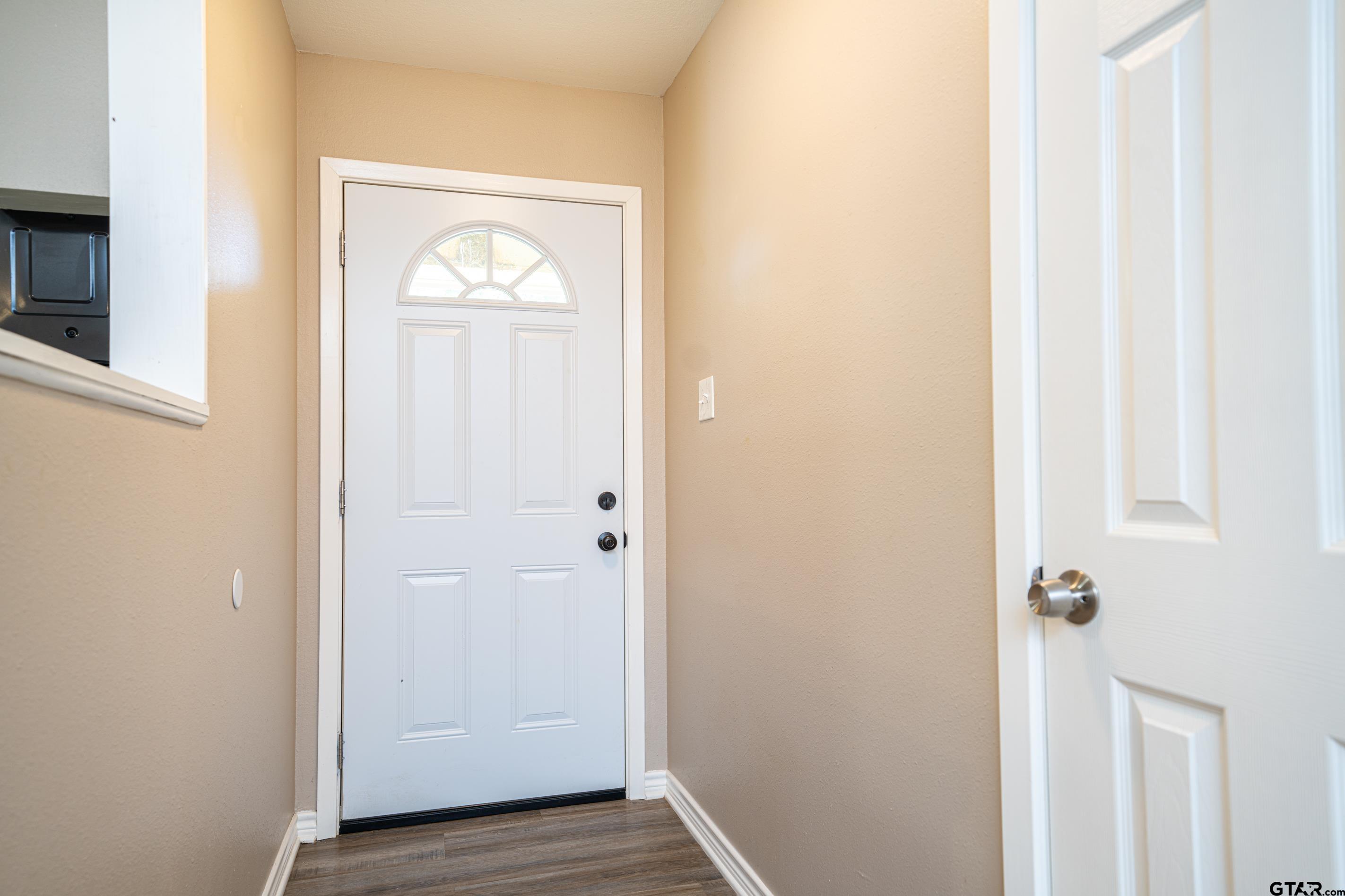 2536 Elk Road Gilmer, TX 75644 - Photo 8 of 32 a view of a hallway with wooden floor