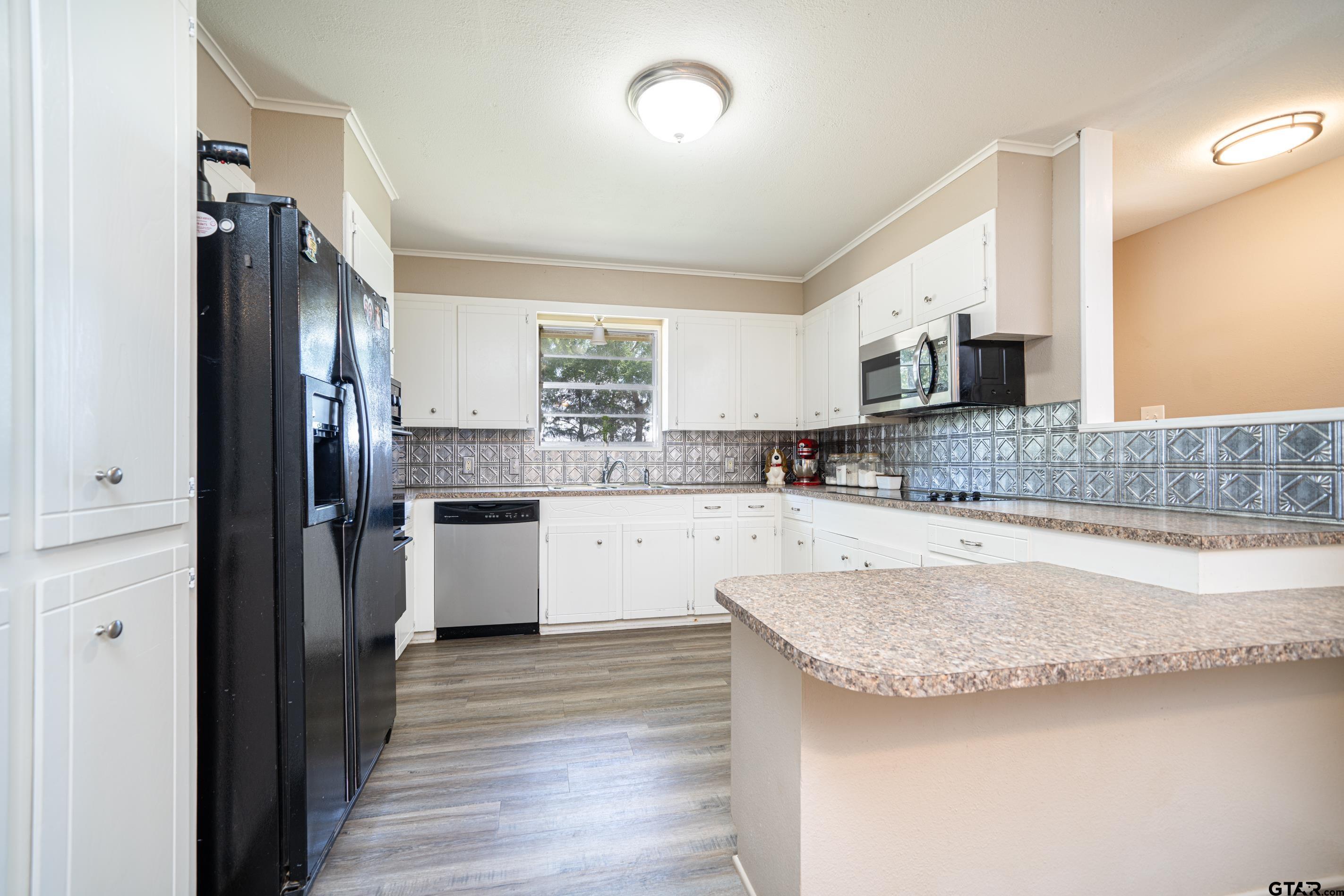 2536 Elk Road Gilmer, TX 75644 - Photo 10 of 32 a kitchen with stainless steel appliances granite countertop a refrigerator a stove and a sink
