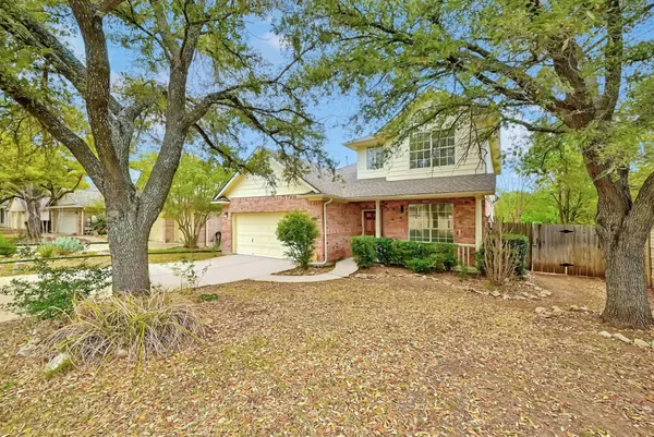a view of a house with a tree in the background