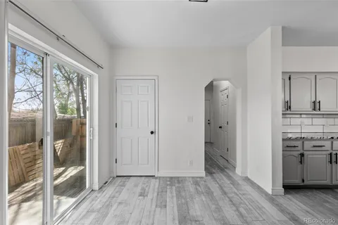 a view of a kitchen with wooden floor and a sink