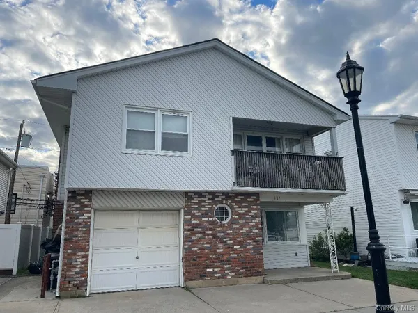 a front view of a house with garage