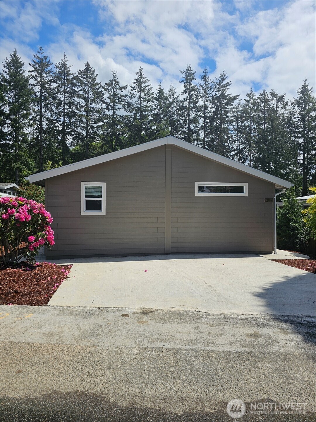 1725 15th Avenue Southeast, Unit 202 Bothell, WA 98021 - Photo 1 of 1 a side view of a house with a yard