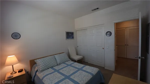 a bedroom with a bed and a chair