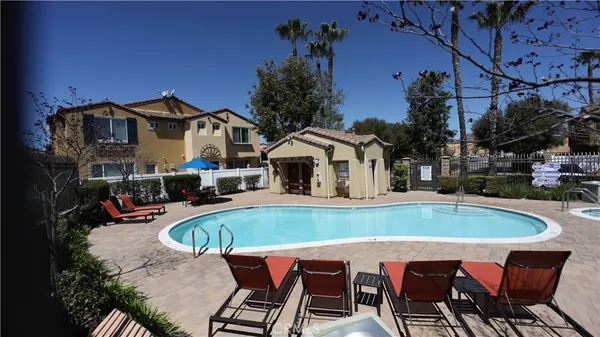 a view of a house with swimming pool and sitting area