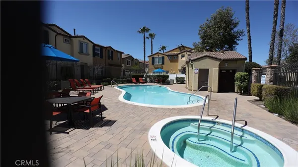 a view of a house with swimming pool and sitting area