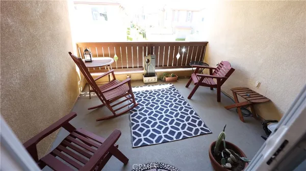 a balcony with a rug and a chair