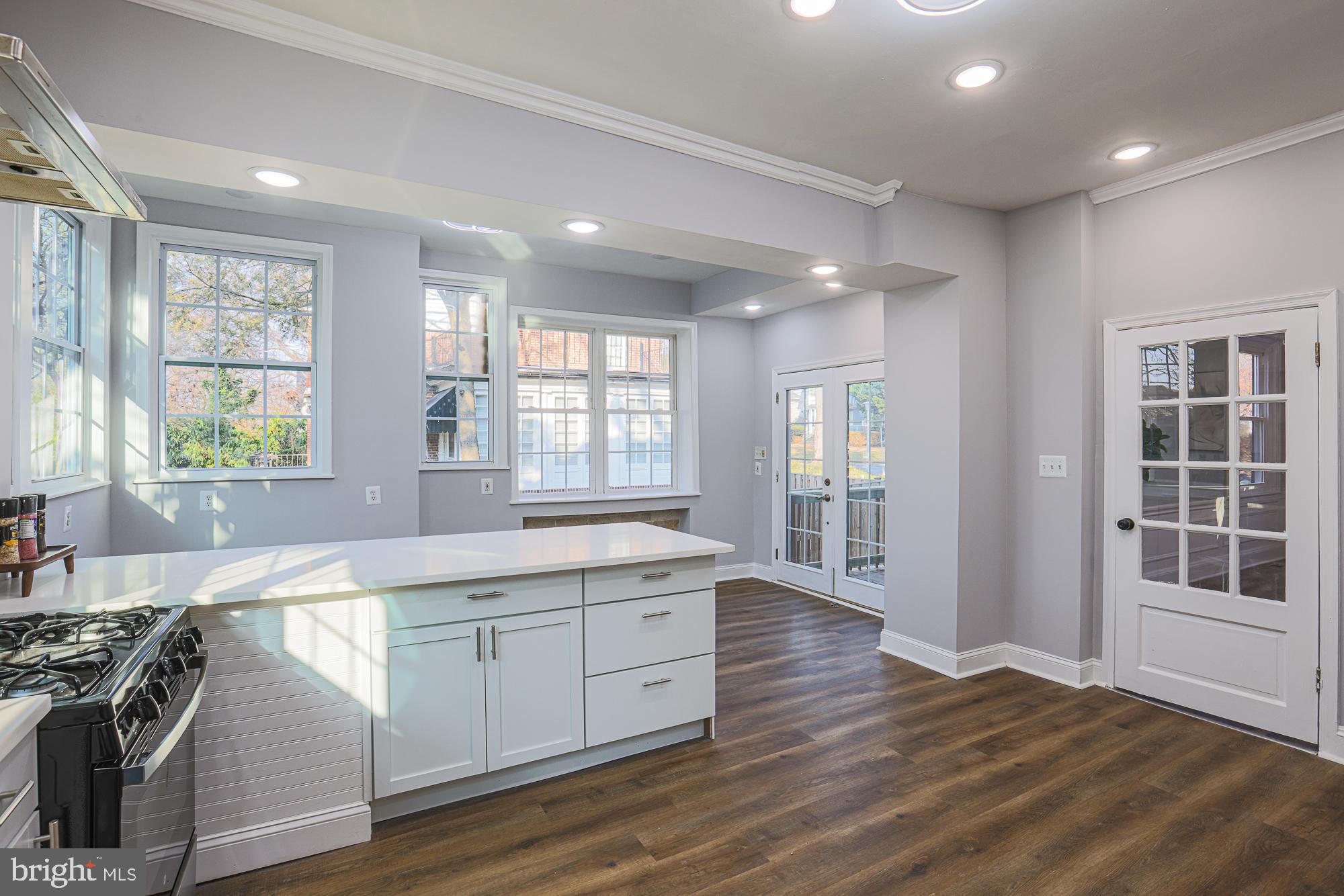 2606 Queen Anne Road Baltimore, MD 21216 - Photo 13 of 92 a large kitchen with stainless steel appliances granite countertop a sink and wooden floors