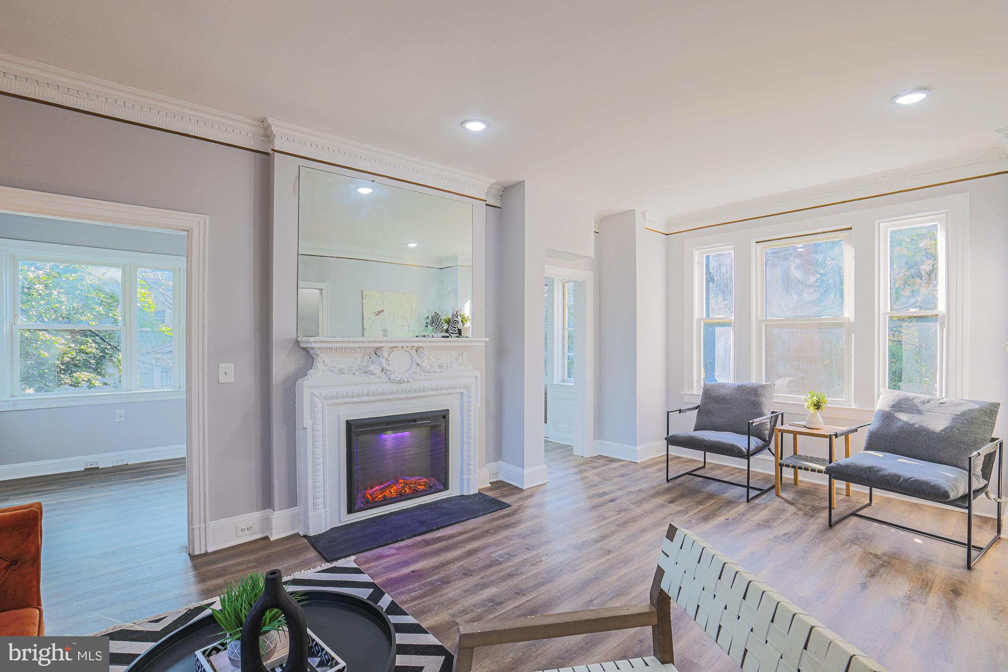 2606 Queen Anne Road Baltimore, MD 21216 - Photo 40 of 92 a living room with furniture a fireplace and a table