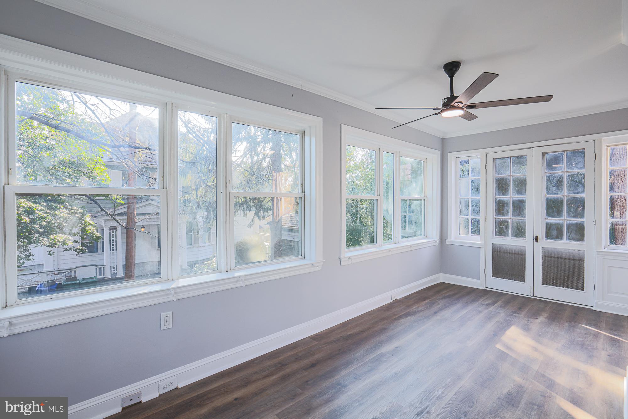 2606 Queen Anne Road Baltimore, MD 21216 - Photo 42 of 92 a view of an empty room with a window and wooden floor
