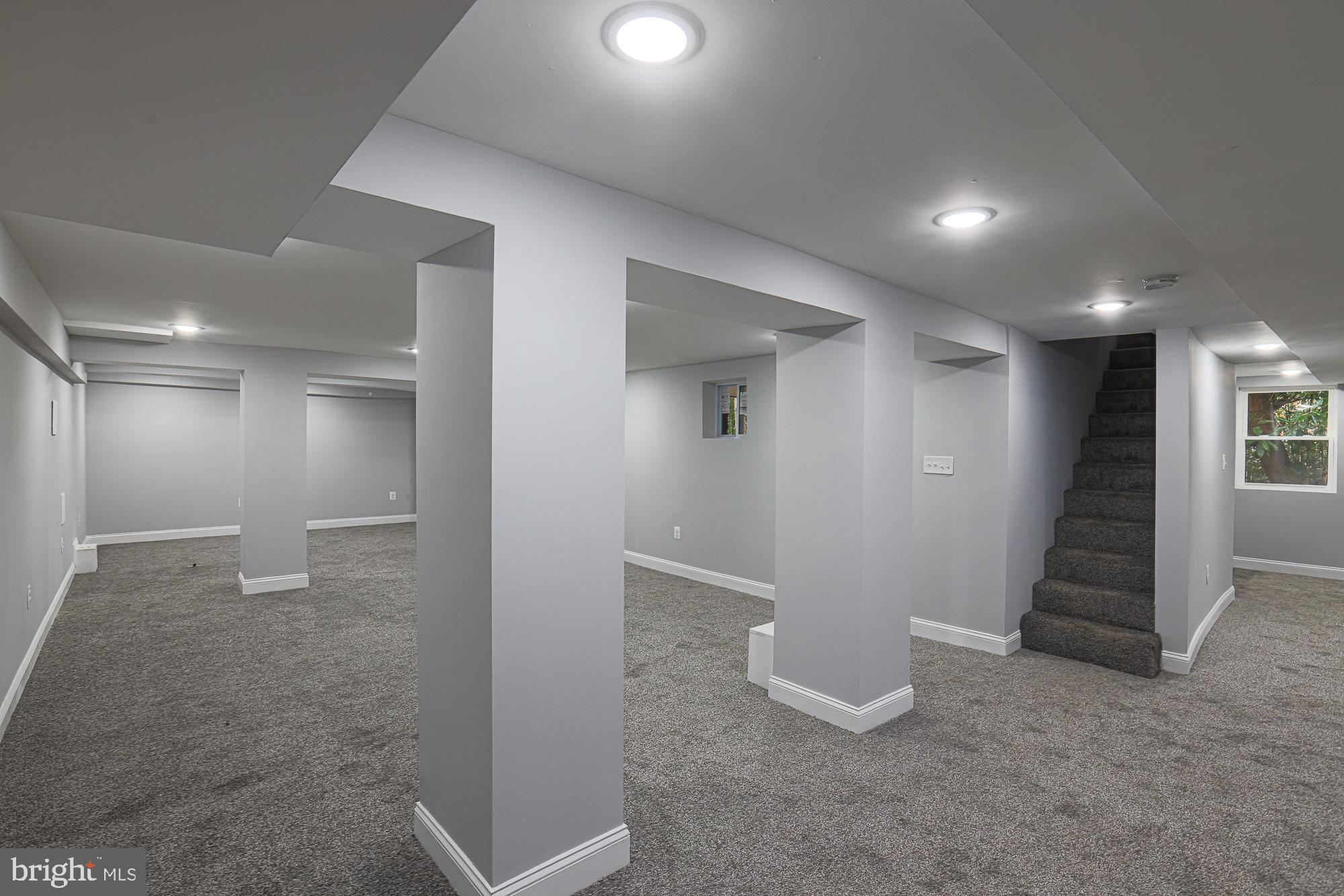 2606 Queen Anne Road Baltimore, MD 21216 - Photo 51 of 92 an empty room with wooden floor and windows