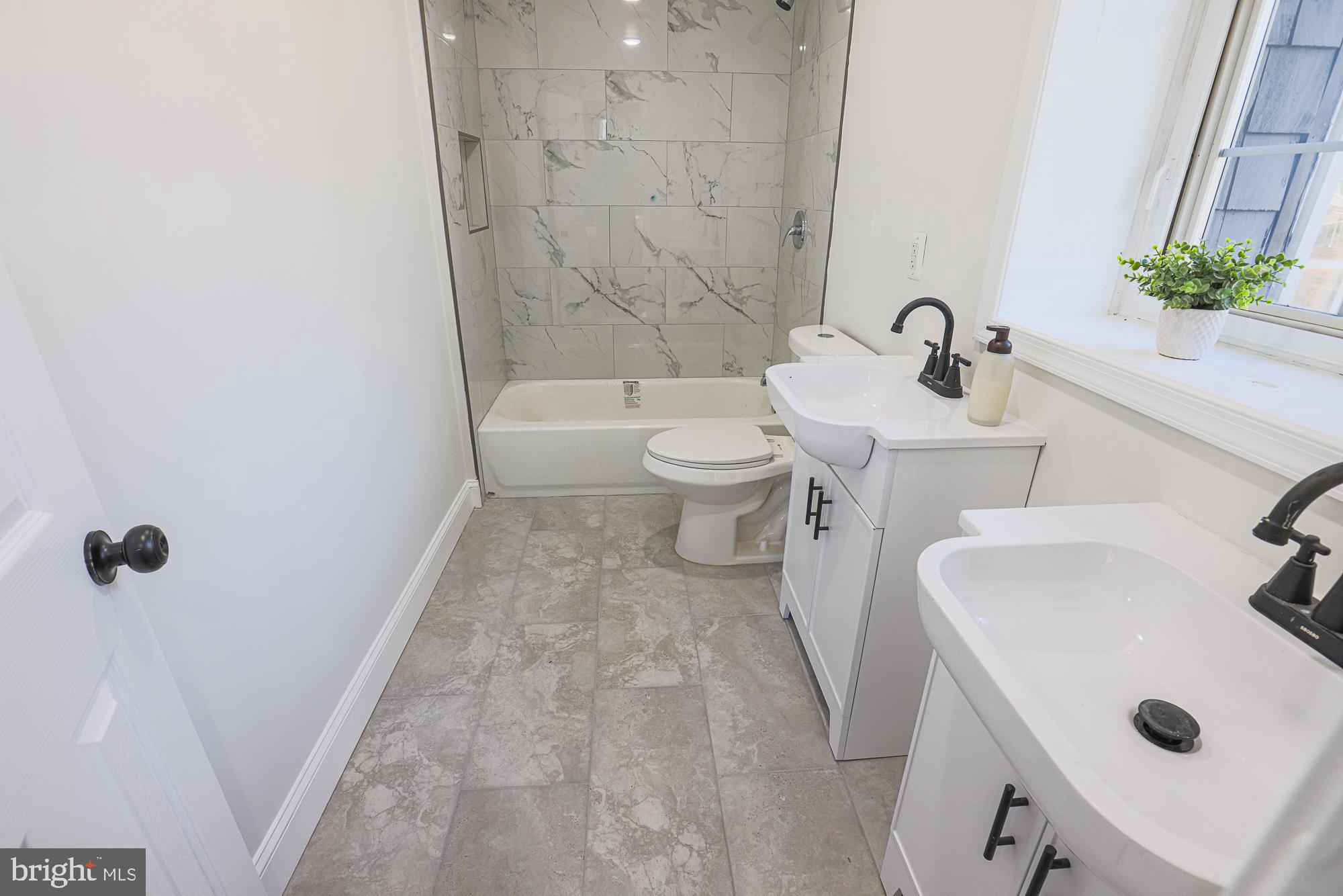 2606 Queen Anne Road Baltimore, MD 21216 - Photo 70 of 92 a bathroom with a sink a toilet and shower
