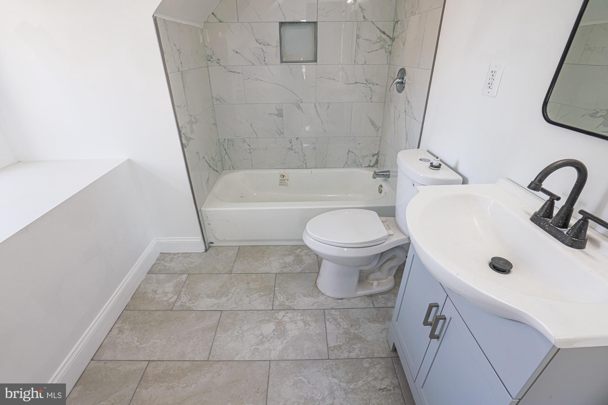 2606 Queen Anne Road Baltimore, MD 21216 - Photo 88 of 92 a bathroom with a sink a toilet and bathtub