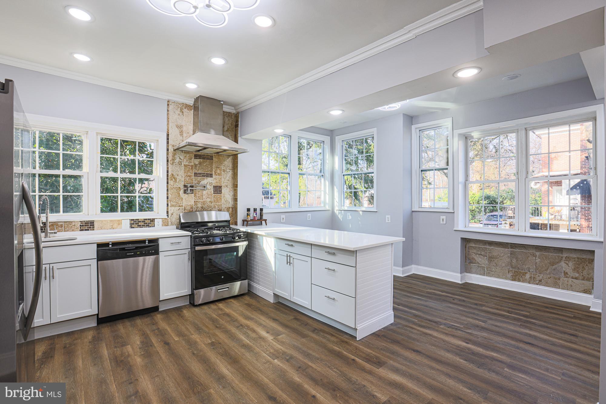2606 Queen Anne Road Baltimore, MD 21216 - Photo 10 of 92 a large kitchen with stainless steel appliances granite countertop a stove and a sink