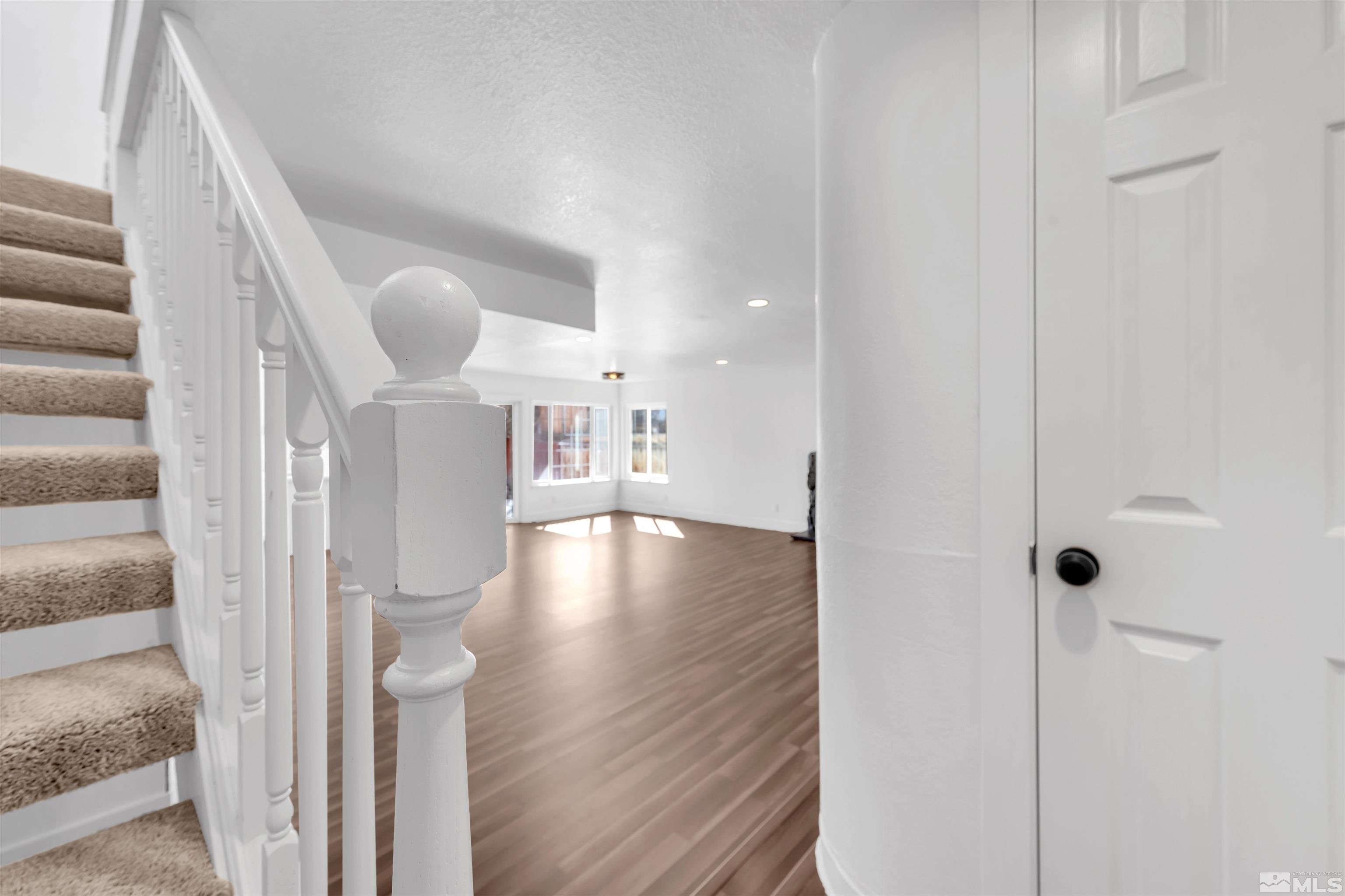 6768 Peppermint Court Reno, NV 89506 - Photo 6 of 40 a view of a hallway view with wooden floor and staircase
