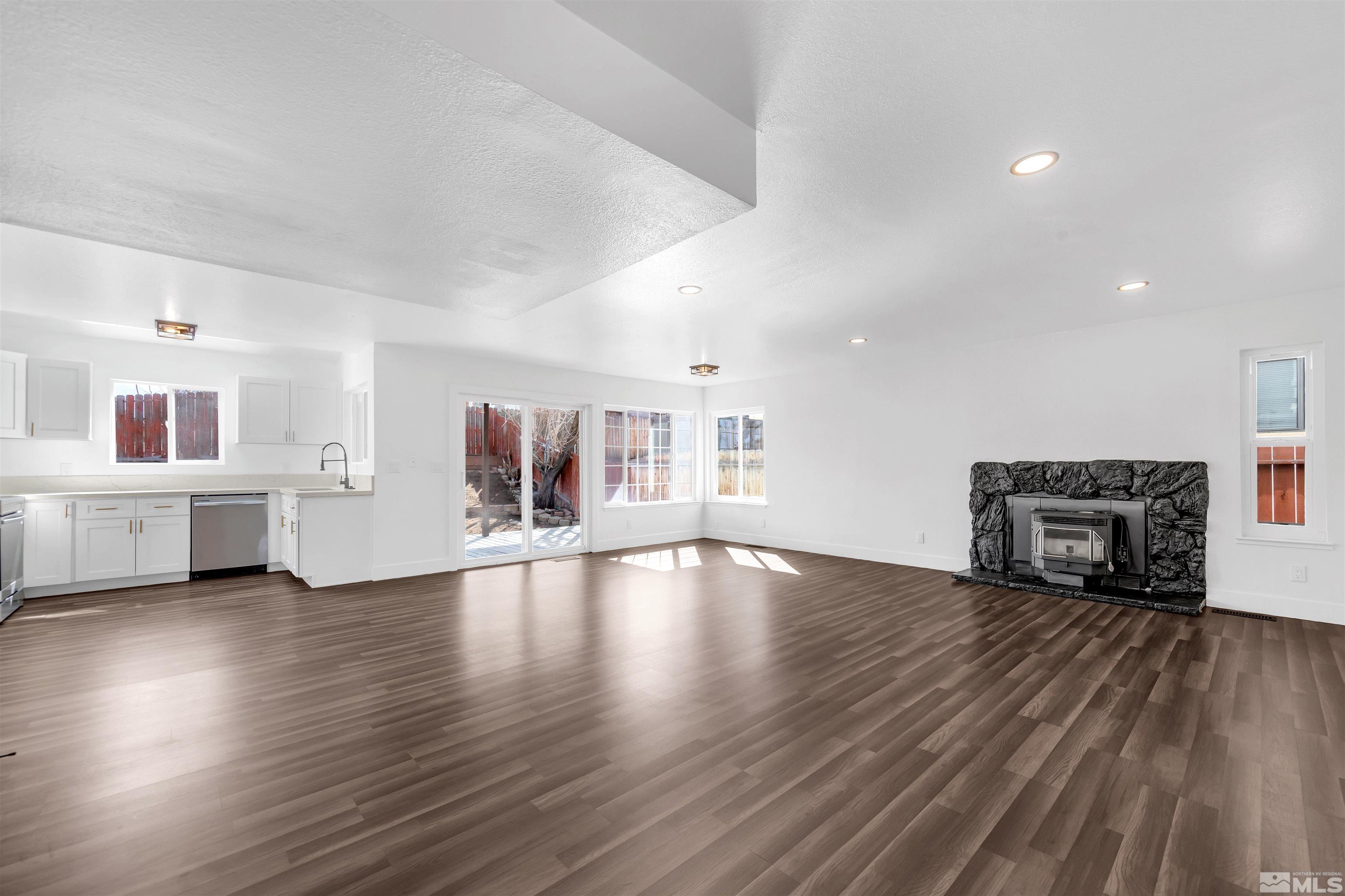 6768 Peppermint Court Reno, NV 89506 - Photo 7 of 40 a view of an empty room with wooden floor and a window