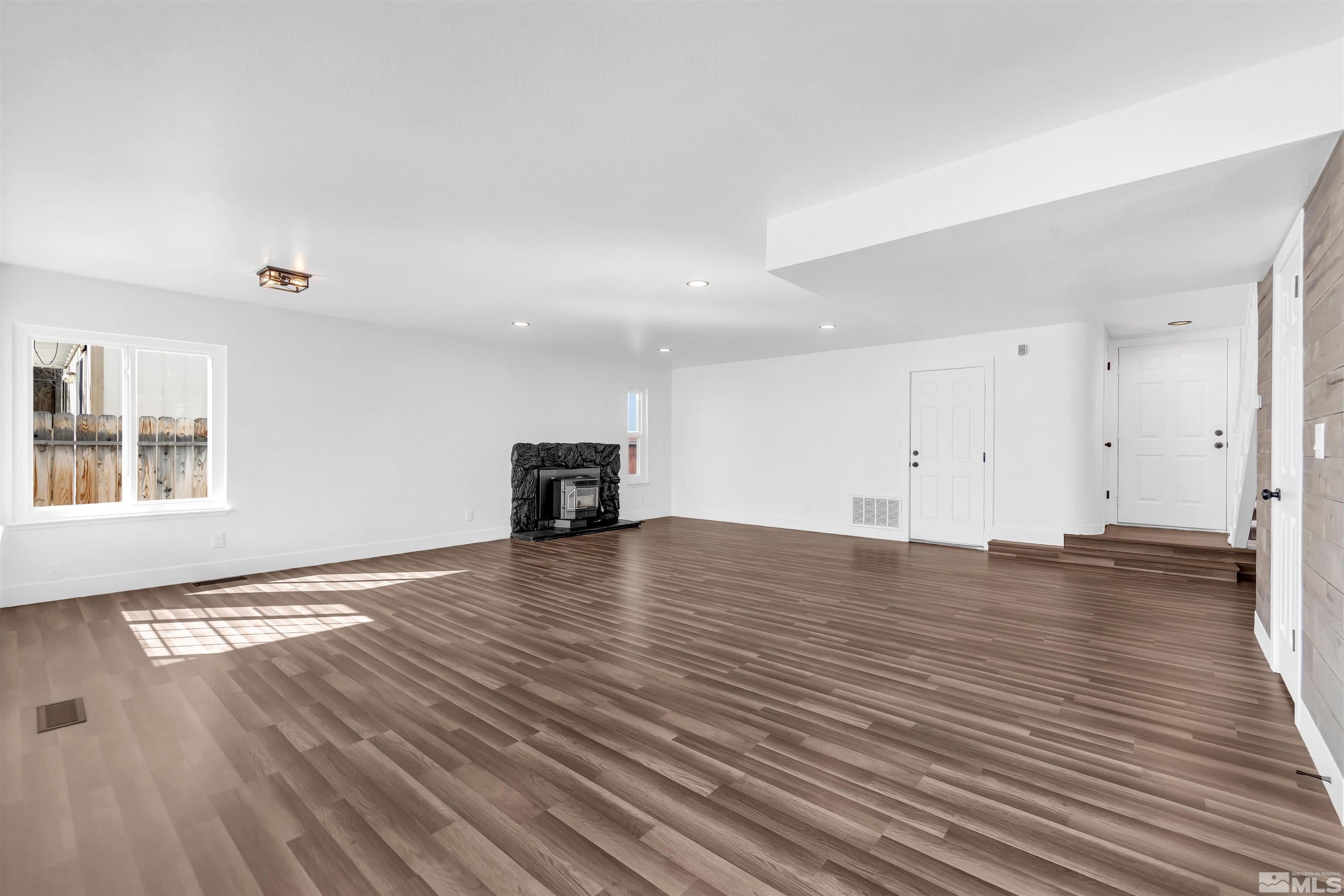 6768 Peppermint Court Reno, NV 89506 - Photo 8 of 40 a view of empty room with wooden floor and fireplace