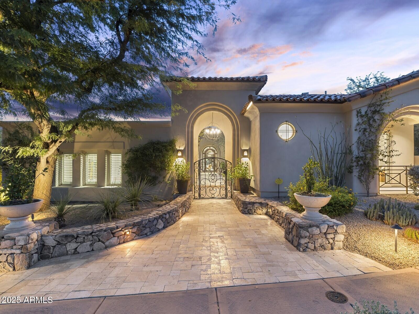 9290 East Thompson Peak Parkway, Unit 142 Scottsdale, AZ 85255 - Photo 1 of 74 a front view of a house with garden