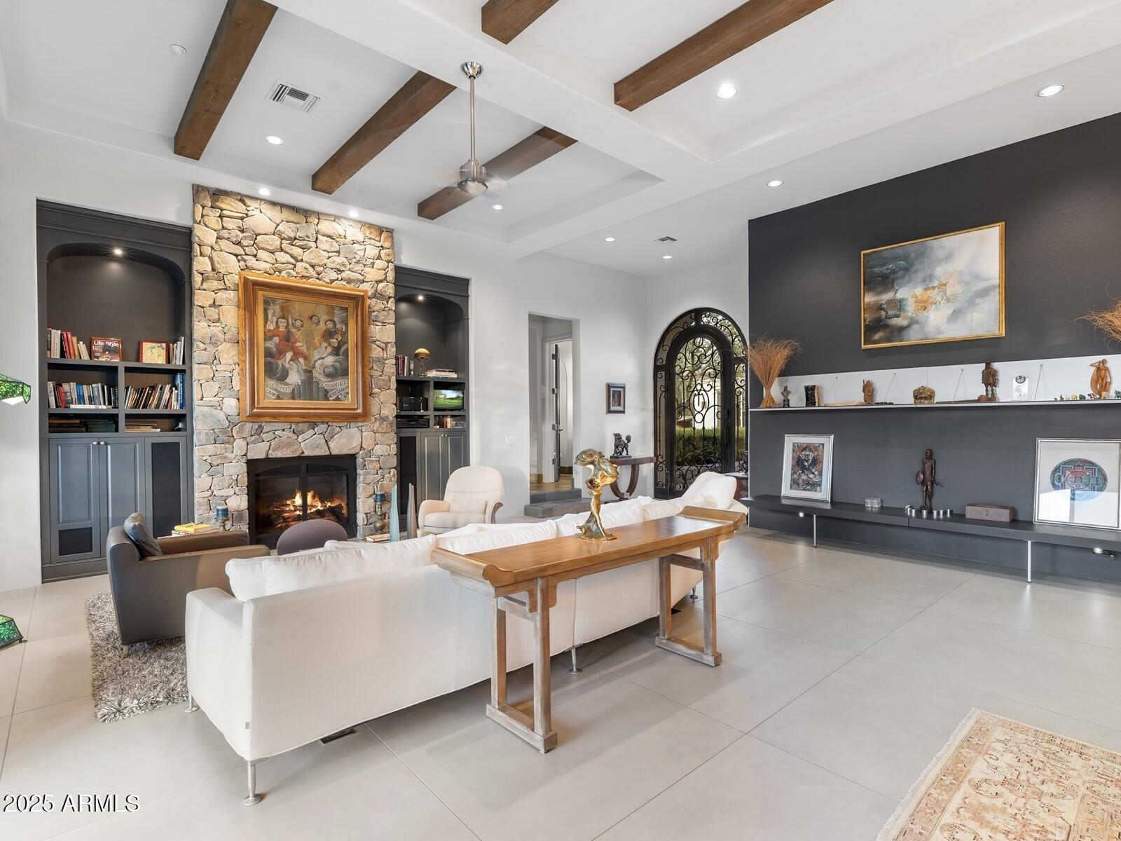 9290 East Thompson Peak Parkway, Unit 142 Scottsdale, AZ 85255 - Photo 13 of 74 a living room with furniture a fireplace and a flat screen tv