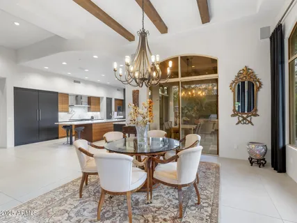 a kitchen with stainless steel appliances granite countertop a sink a stove and a refrigerator