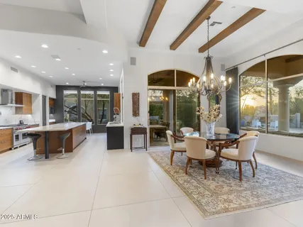 a large kitchen with kitchen island a large counter top space a sink stainless steel appliances and cabinets