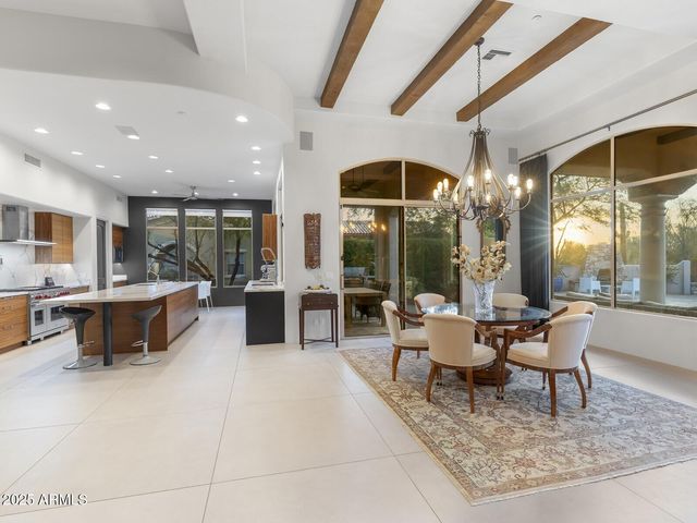 a kitchen with stainless steel appliances granite countertop a sink a stove and a refrigerator