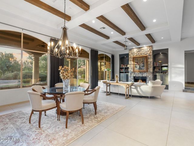 a large kitchen with kitchen island a large counter top space a sink stainless steel appliances and cabinets