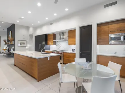 a spacious bathroom with a double vanity sink a large mirror and a bathtub