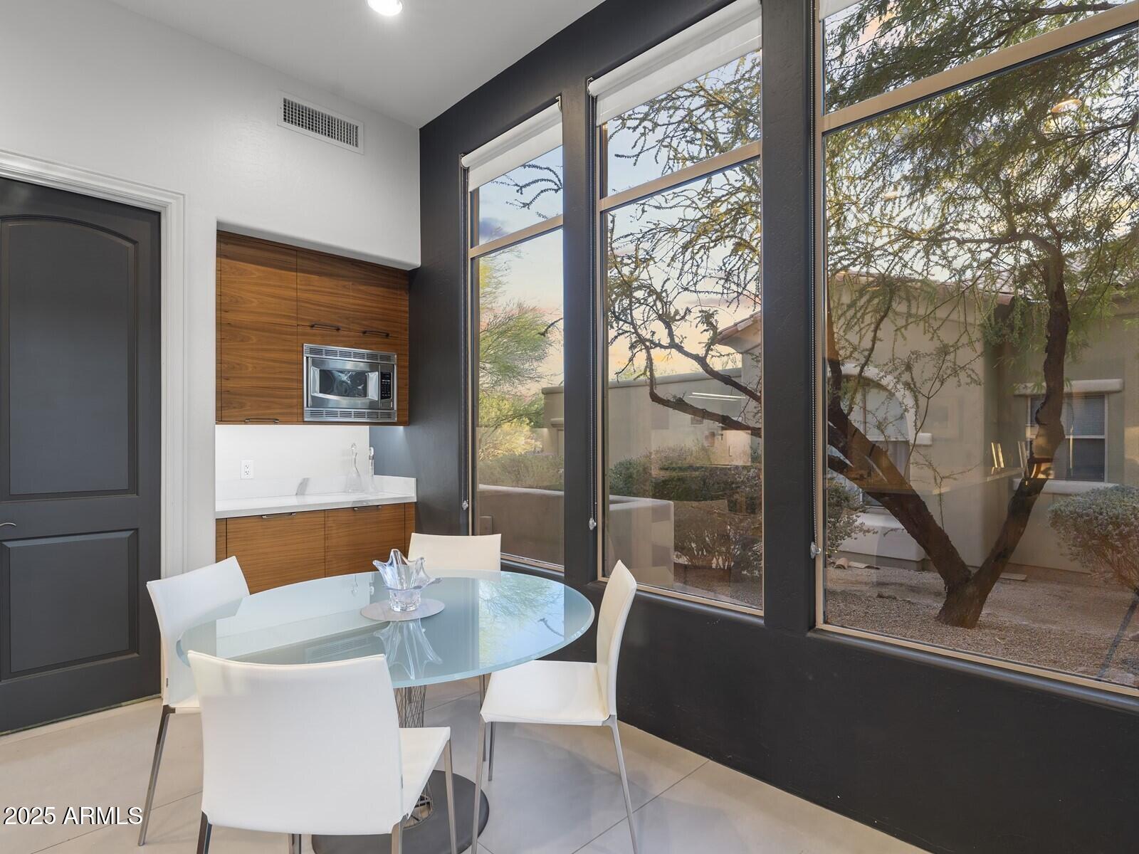 9290 East Thompson Peak Parkway, Unit 142 Scottsdale, AZ 85255 - Photo 23 of 74 a view of a dining room with furniture window and outside view