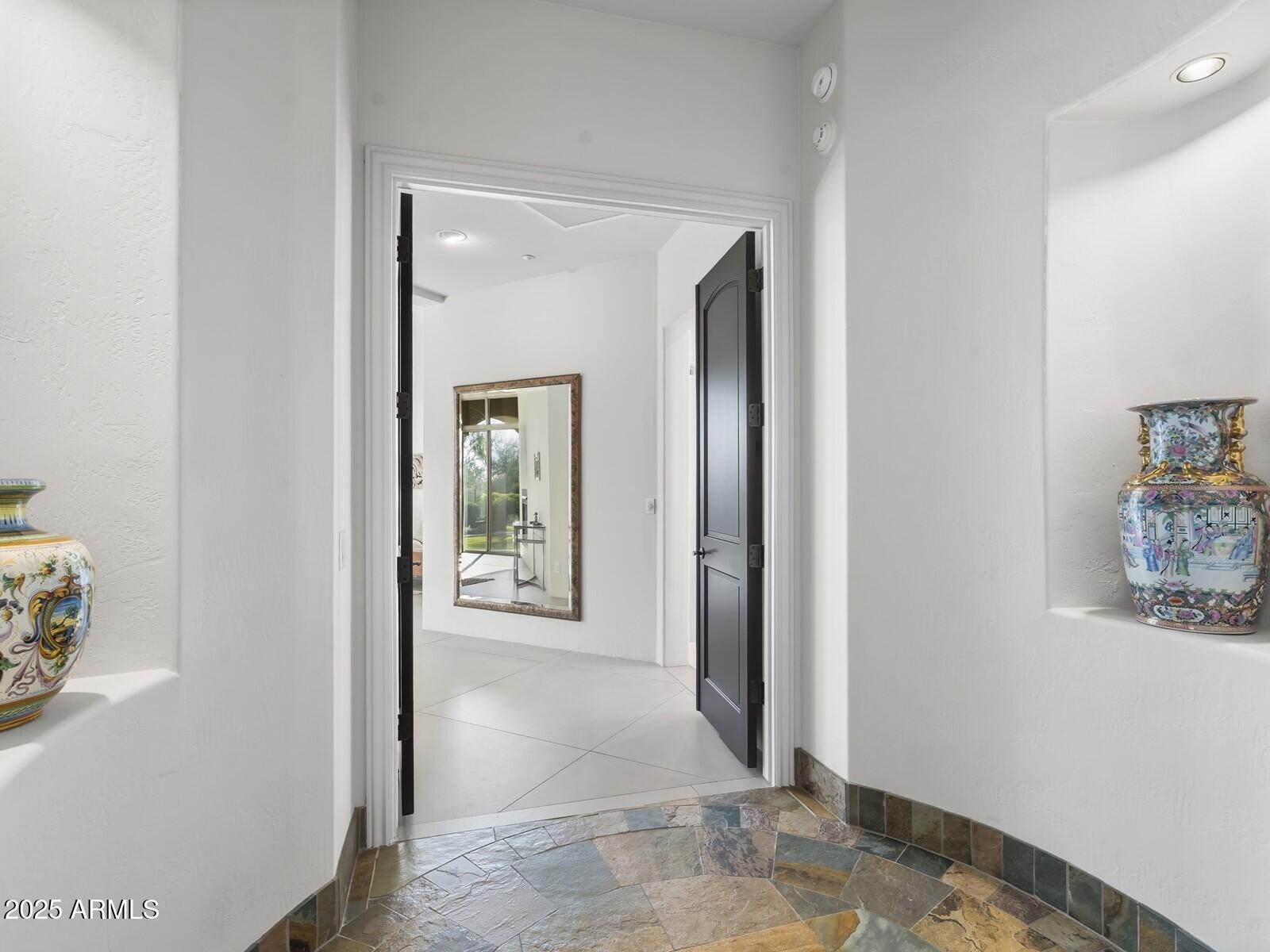 9290 East Thompson Peak Parkway, Unit 142 Scottsdale, AZ 85255 - Photo 24 of 74 a view of a hallway with paintings on the wall
