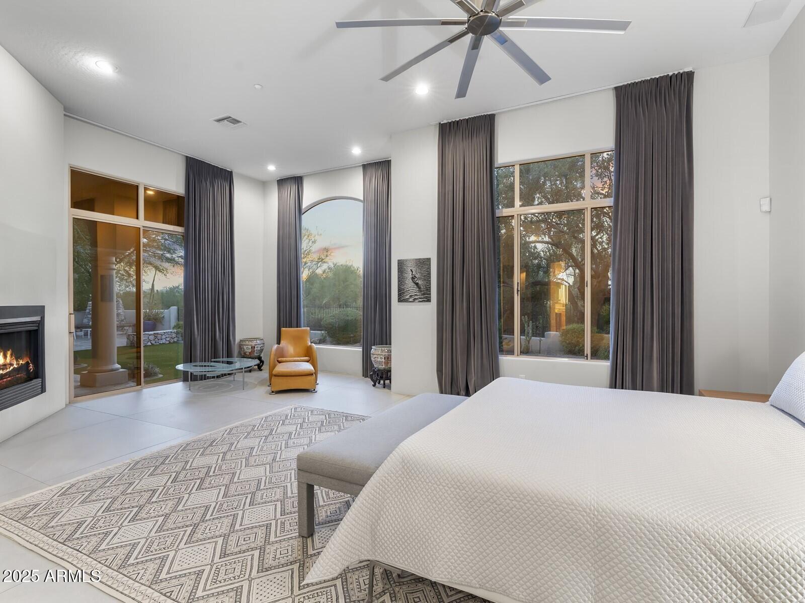 9290 East Thompson Peak Parkway, Unit 142 Scottsdale, AZ 85255 - Photo 27 of 74 a bedroom with a bed and large windows