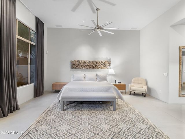 a living room with furniture a floor to ceiling window and a floor to ceiling window