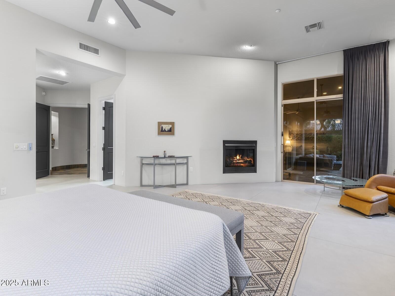 9290 East Thompson Peak Parkway, Unit 142 Scottsdale, AZ 85255 - Photo 29 of 74 a spacious bedroom with a bed and a couch