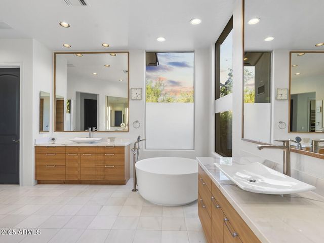 a view of a tables and chairs in a backyard