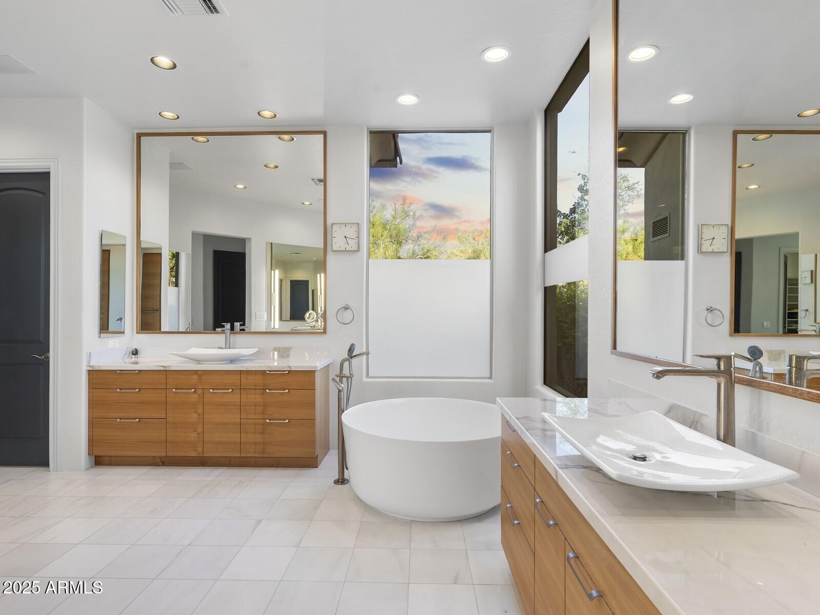 9290 East Thompson Peak Parkway, Unit 142 Scottsdale, AZ 85255 - Photo 34 of 74 a bathroom with a tub a sink and double vanity