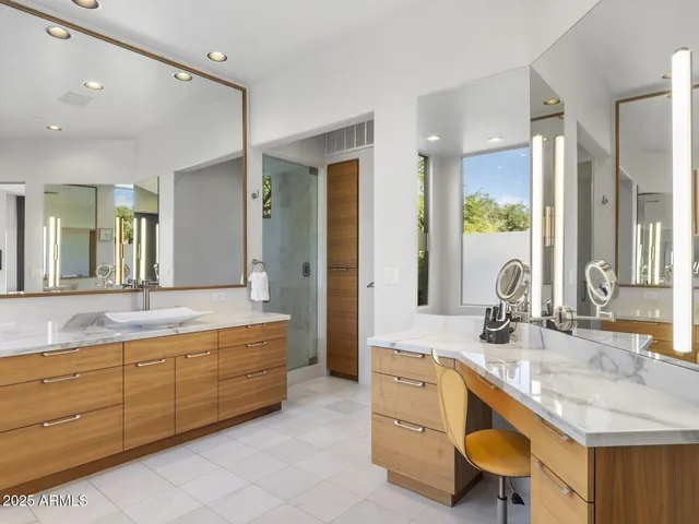 a view of a patio with a table chairs and a floor to ceiling window