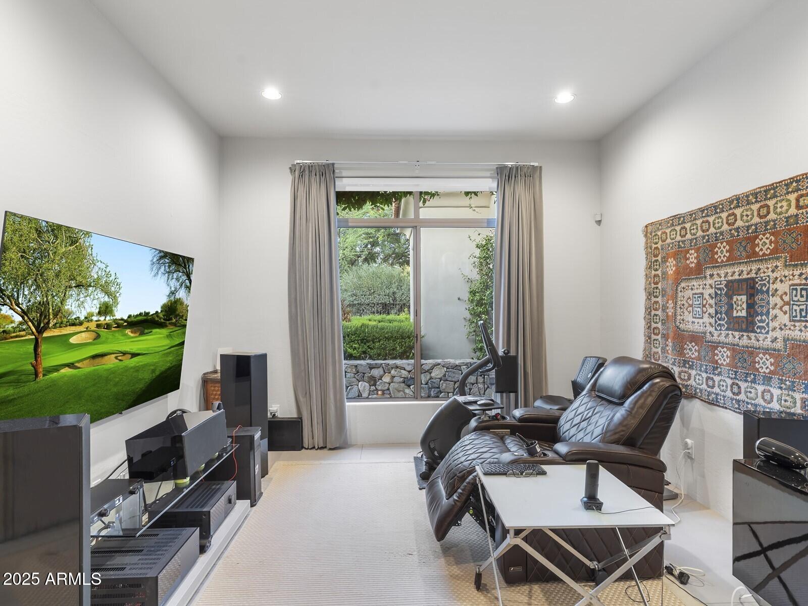 9290 East Thompson Peak Parkway, Unit 142 Scottsdale, AZ 85255 - Photo 37 of 74 a living room with furniture a floor to ceiling window and a floor to ceiling window