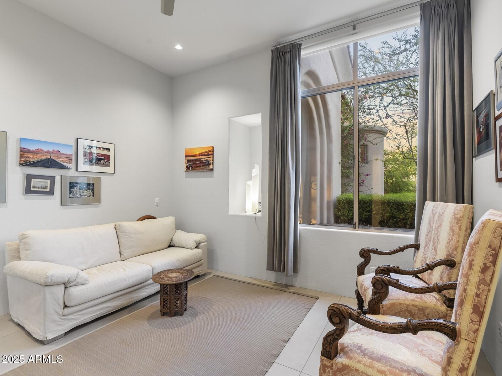 9290 East Thompson Peak Parkway, Unit 142 Scottsdale, AZ 85255 - Photo 40 of 74 a living room with furniture and a large window