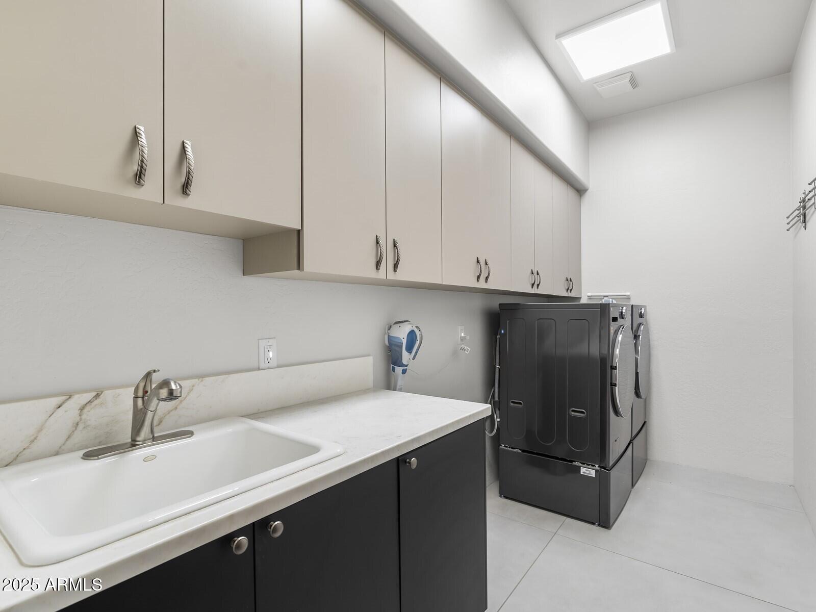 9290 East Thompson Peak Parkway, Unit 142 Scottsdale, AZ 85255 - Photo 42 of 74 a kitchen with a sink and cabinets