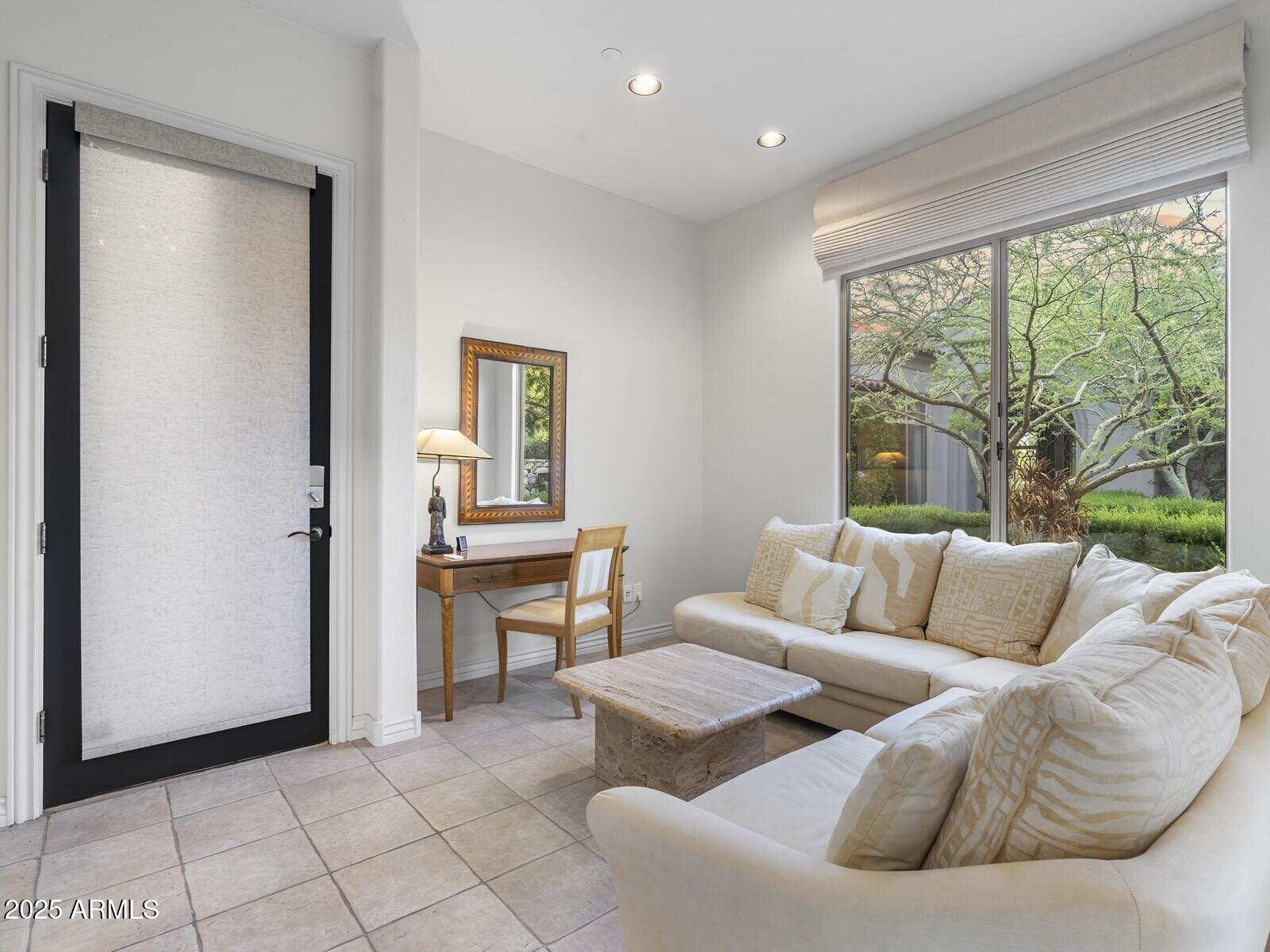 9290 East Thompson Peak Parkway, Unit 142 Scottsdale, AZ 85255 - Photo 56 of 74 a living room with furniture and a window