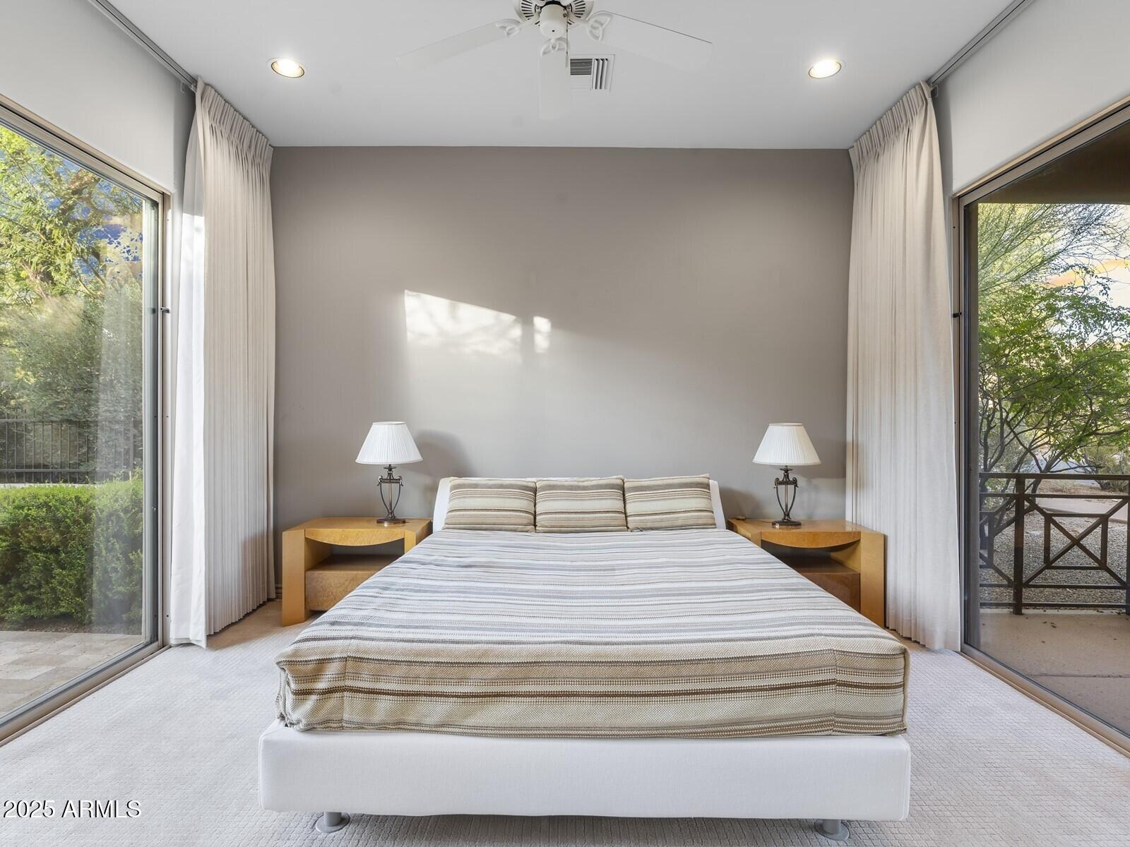 9290 East Thompson Peak Parkway, Unit 142 Scottsdale, AZ 85255 - Photo 58 of 74 a bedroom with a bed and large windows