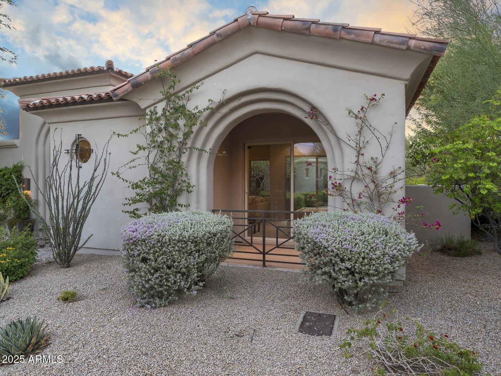 9290 East Thompson Peak Parkway, Unit 142 Scottsdale, AZ 85255 - Photo 60 of 74 a front view of a house with garden