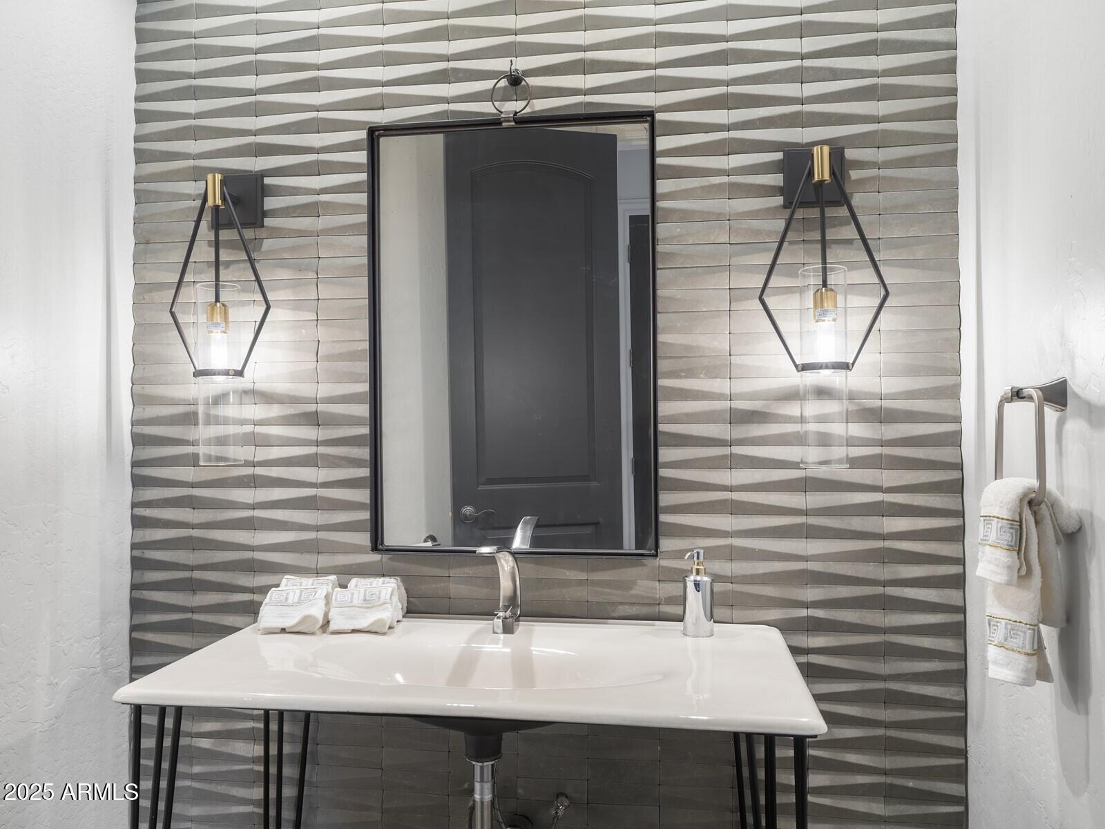9290 East Thompson Peak Parkway, Unit 142 Scottsdale, AZ 85255 - Photo 64 of 74 a bathroom with a sink and a mirror
