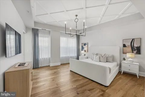 a living room with furniture and large windows