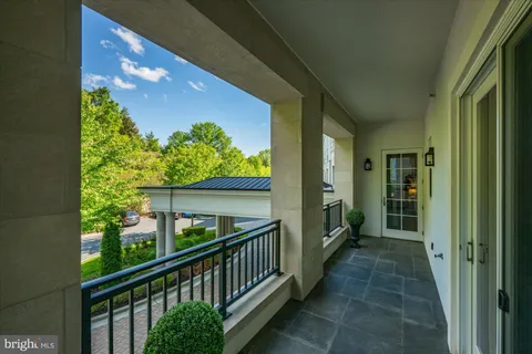 a patio with glass top table and chairs