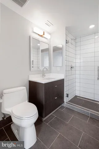 a bathroom with a toilet sink and shower