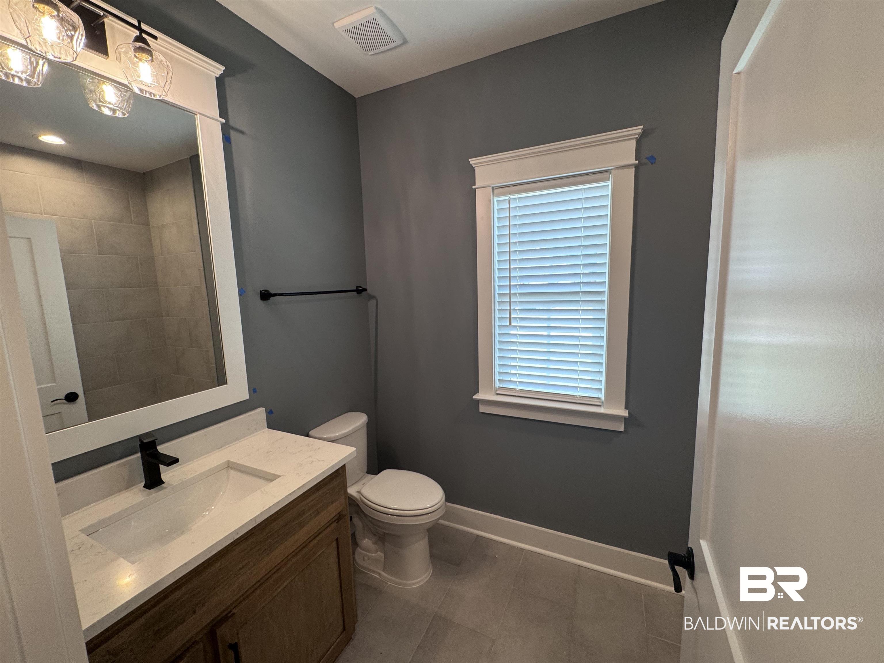 27371 Patch Pl Loop Daphne, AL 36526 - Photo 39 of 63 Bathroom with vanity and dark tile patterned flooring